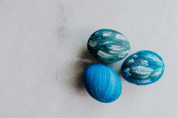 3 blue painted eggs