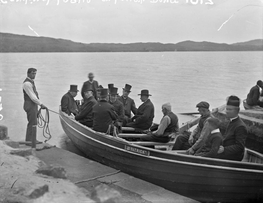 black and white photo of men on a boat