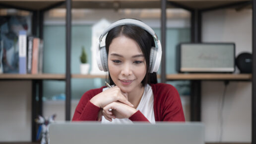 woman with headphones attending an online event