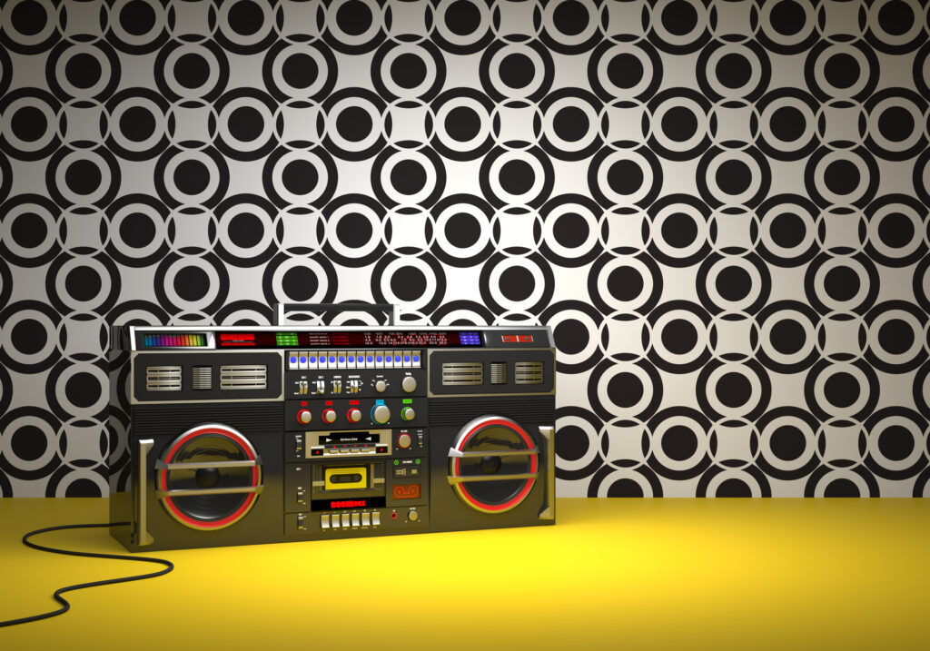 Boom box against the retro style wall in 80's brand colors.