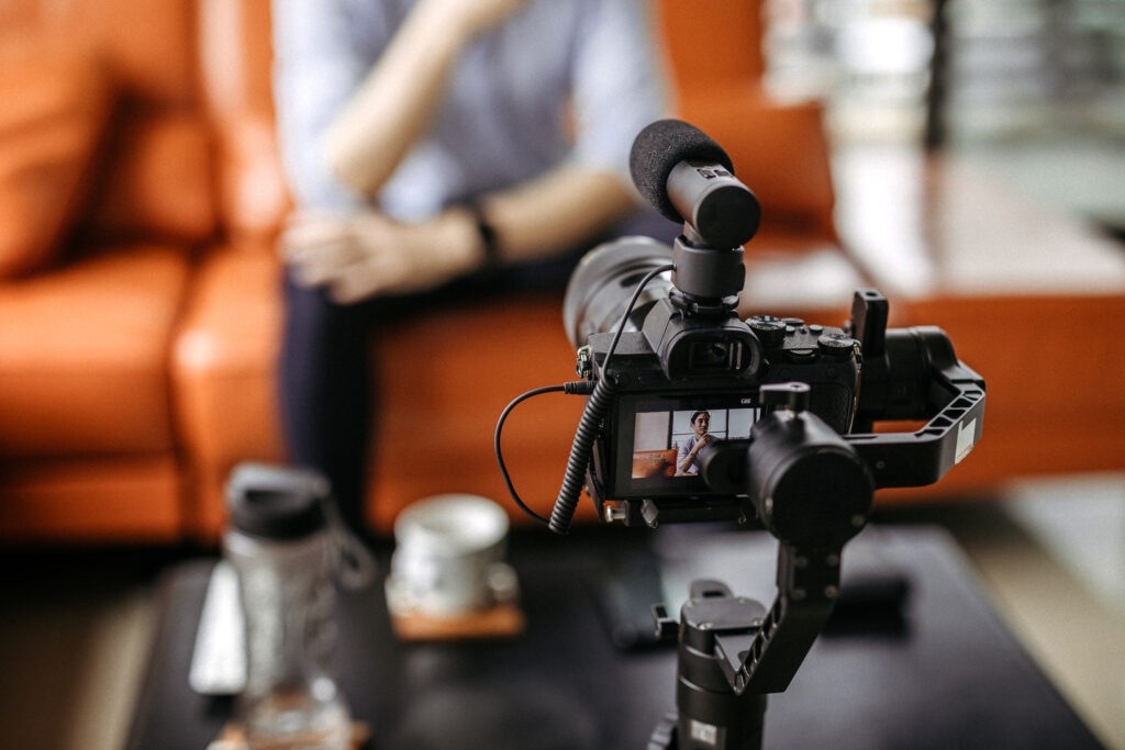 man recording a video on couch