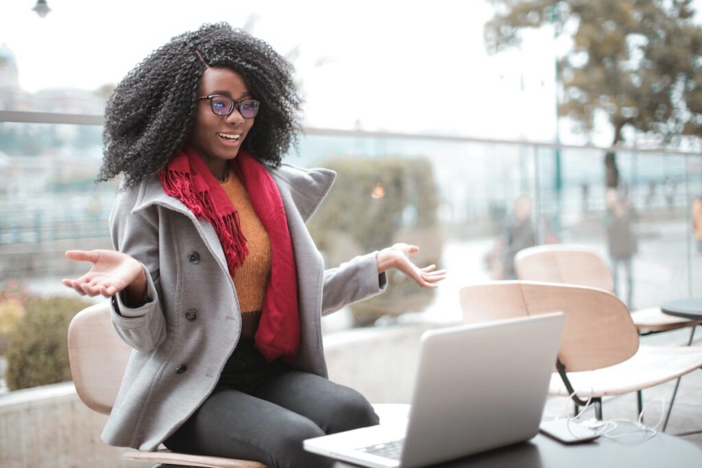 woman talks on video conference outside with a jacket on