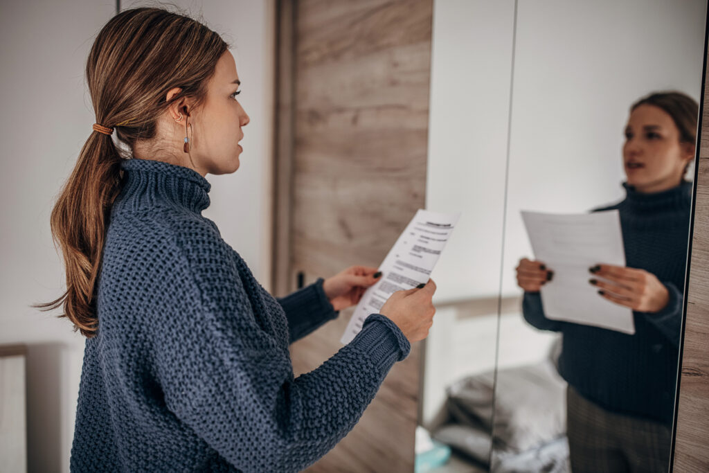 women practicing her speech in front of a mirror