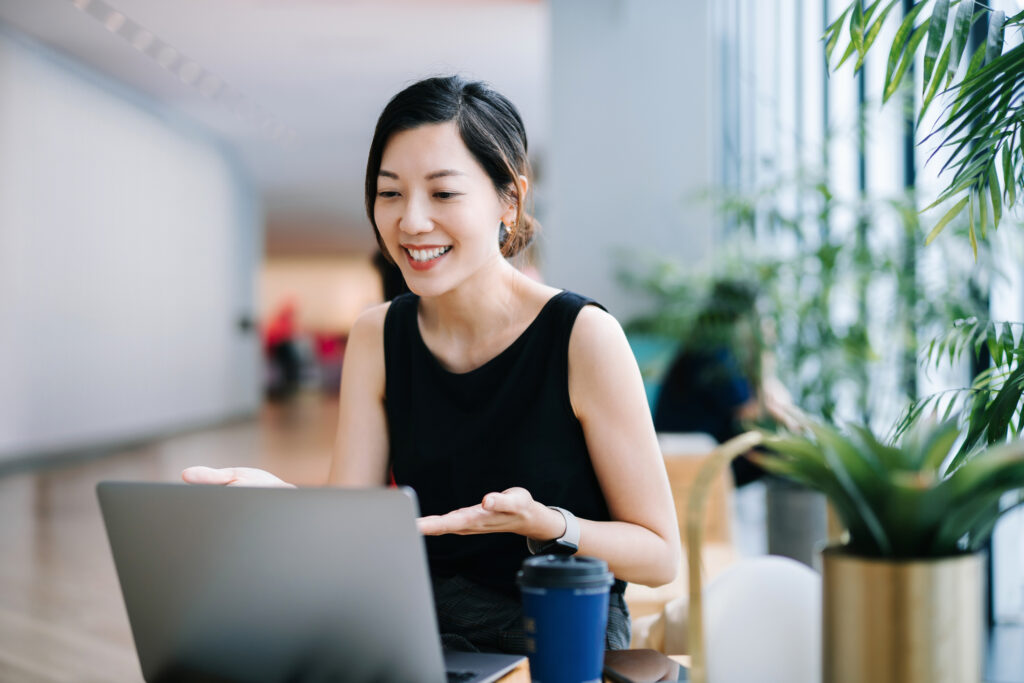 Smiling professional young women giving a good presentation online.