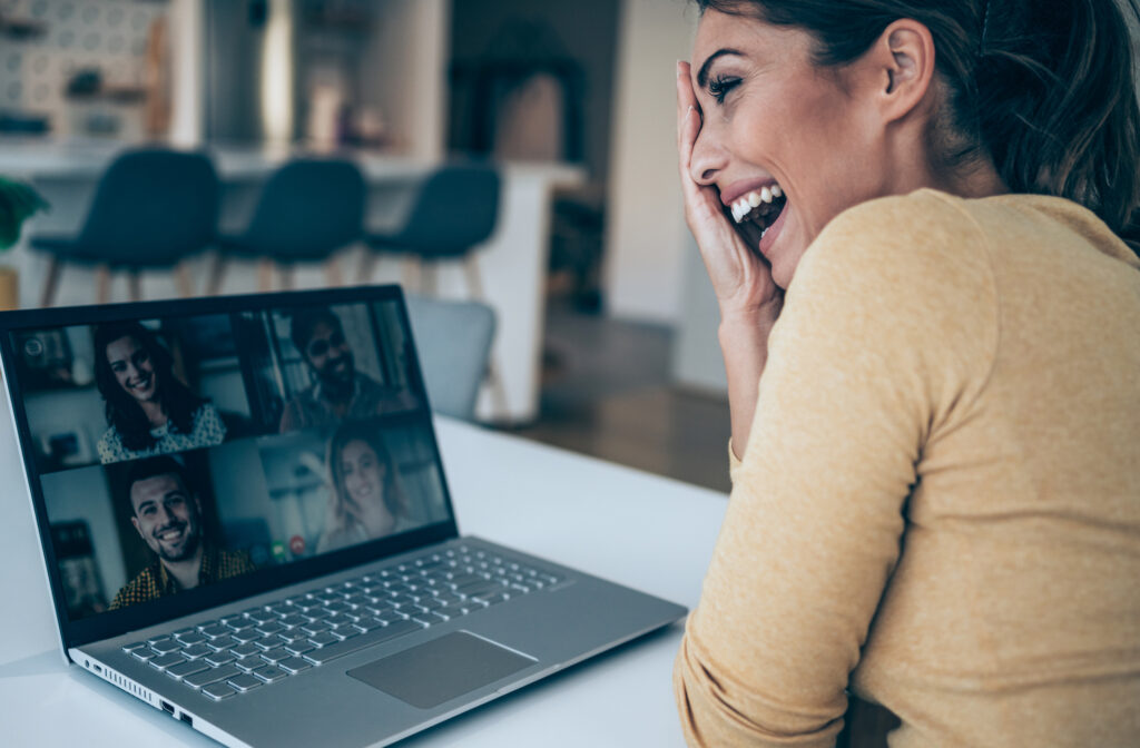 young woman talking to her friends in video call from home