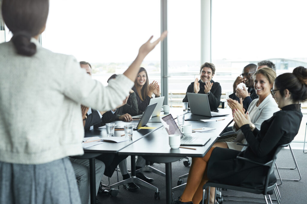 good presentation topics: a woman giving a presentation in a business meeting