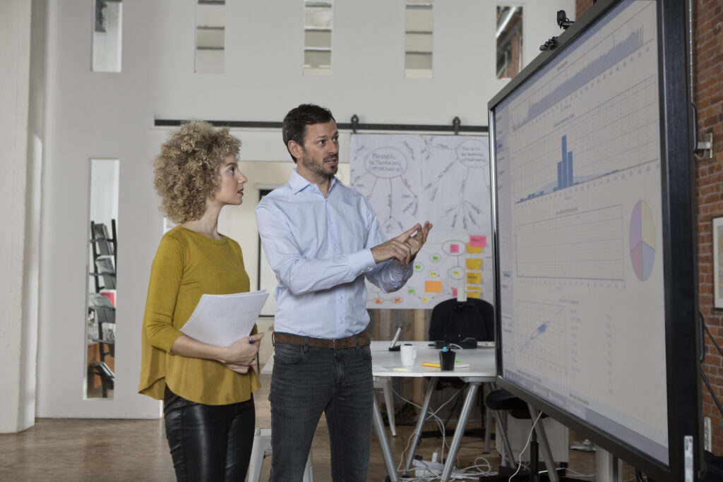 Two people preparing for a presentation for co-presenting.