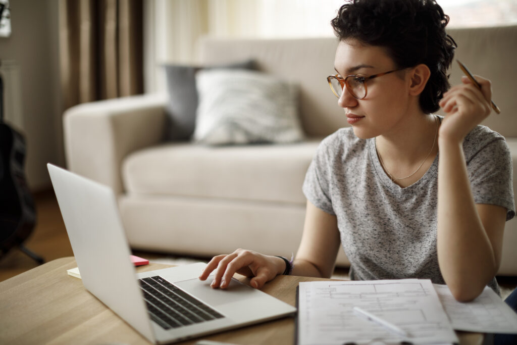 Young woman working at home, working on her business presentation. 