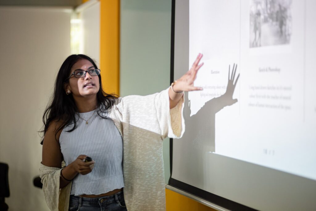 A women presenting a presentation with a school presentation theme