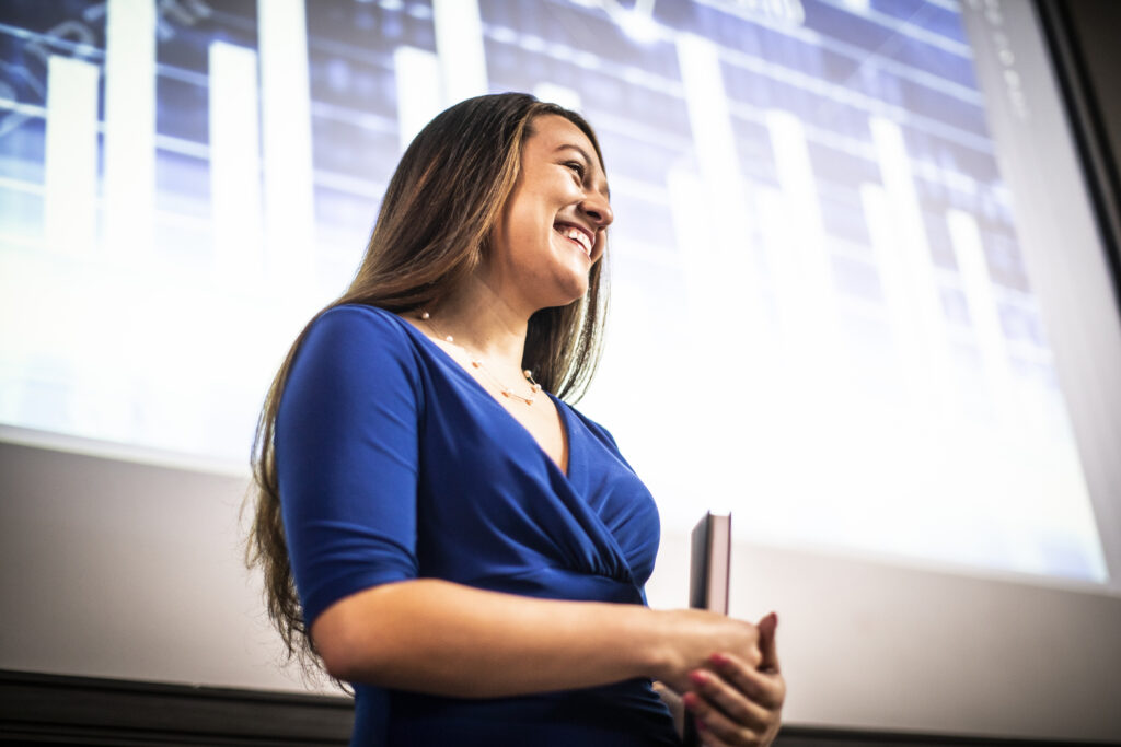 Young professional woman giving presentation during a presentation night