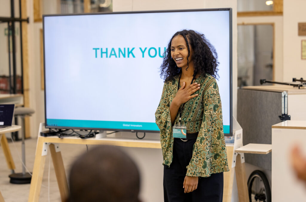 Young businesswoman saying thank-you to audience after seminar. Happy businesswoman smiling and saying thank-you to her team in office.