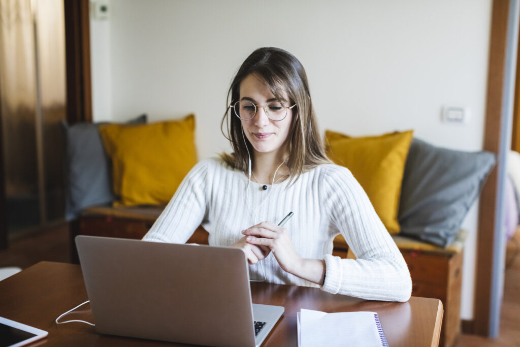 Student woman during online training on laptop at home
