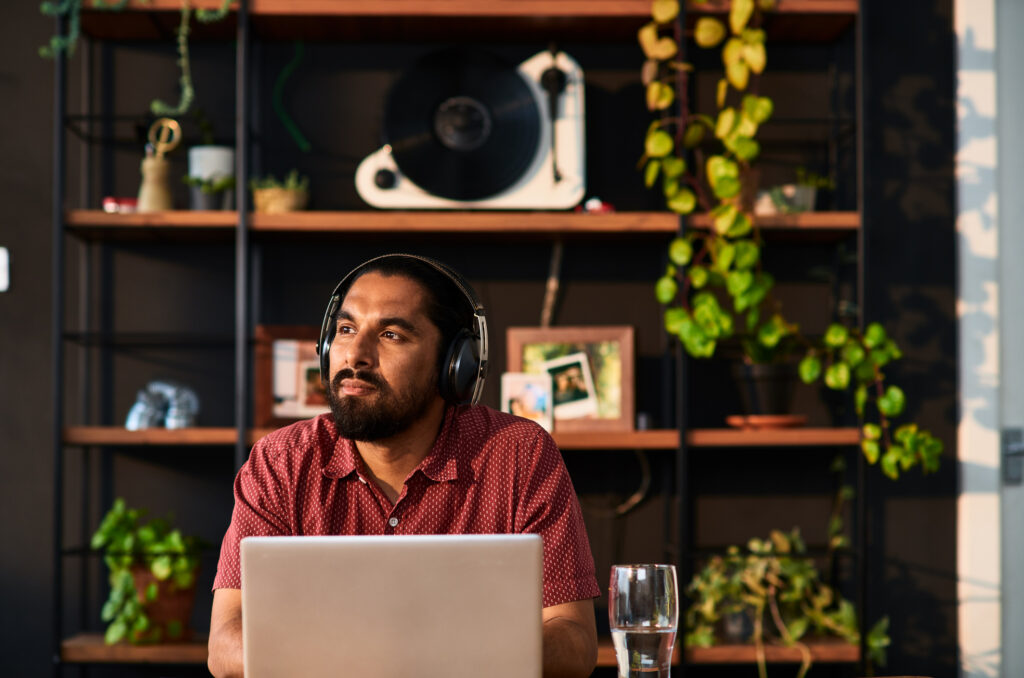 Man in his 30s with beard remote working, contemplation, aspiration, new beginnings, business strategy