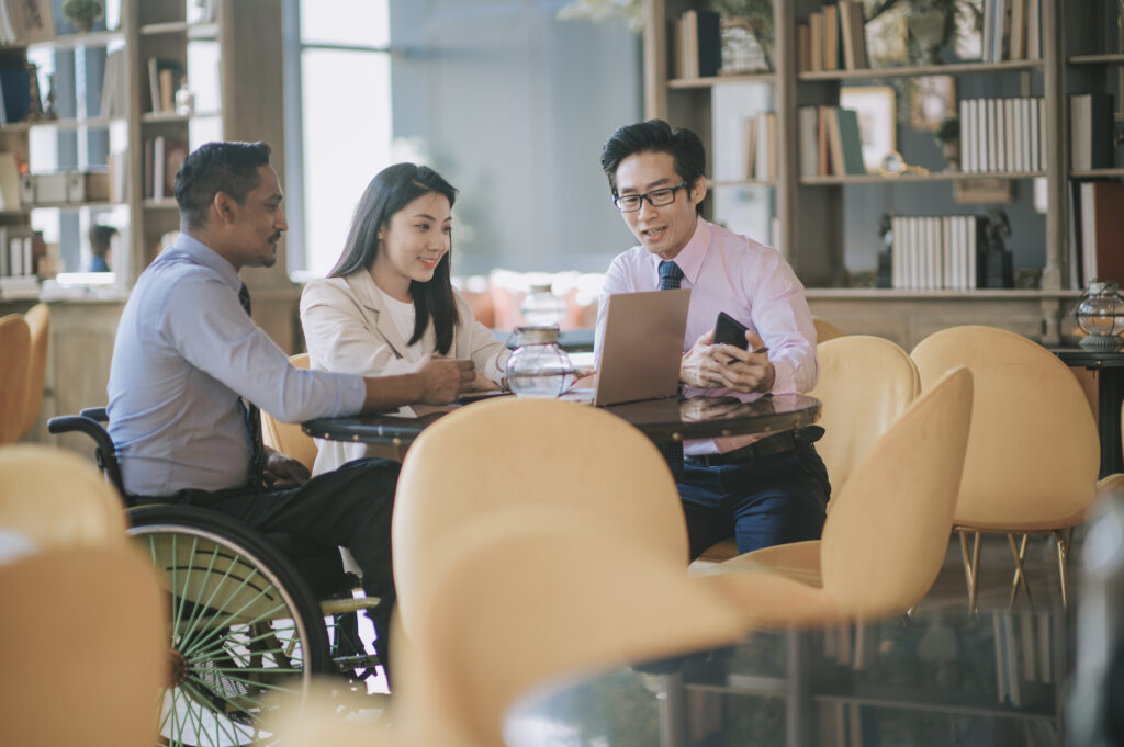 Businessman leading group discussion in cafe