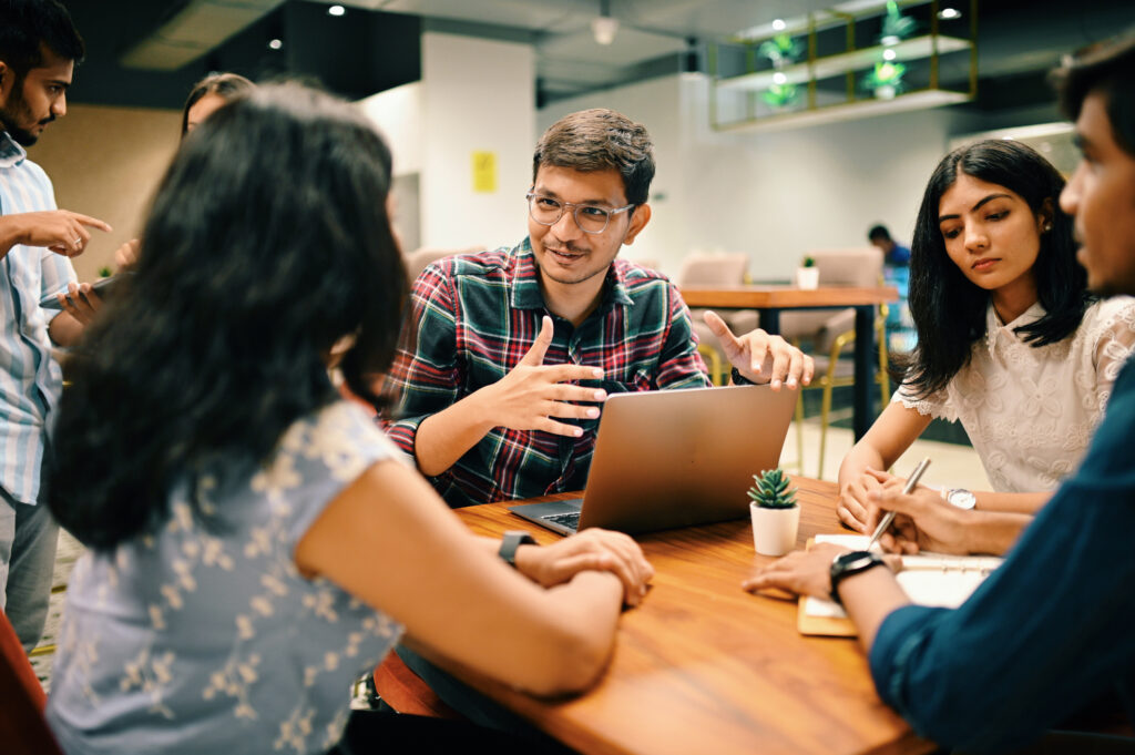 Group of young people discussing new venture set up in the co-working office