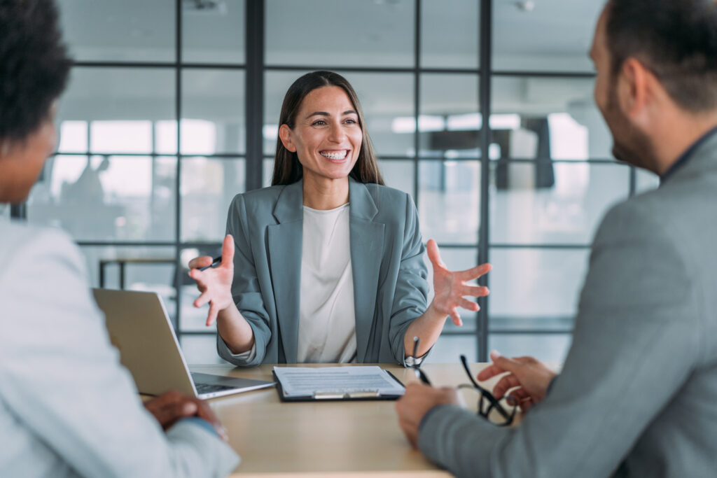 Shot of group of business persons in business meeting. Three entrepreneurs on meeting in board room. Corporate business team on meeting in modern office. Female manager discussing new project with her colleagues. Company owner on a meeting with two of her employees in her office.