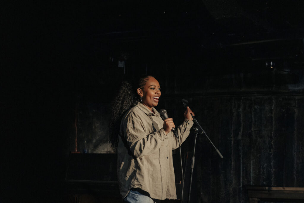 A woman performing on stage, telling a story.