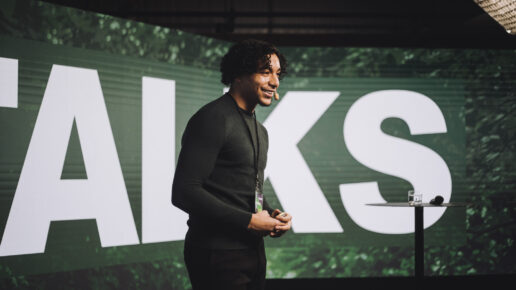 A man presenting on stage using the storytelling style presentation technique.