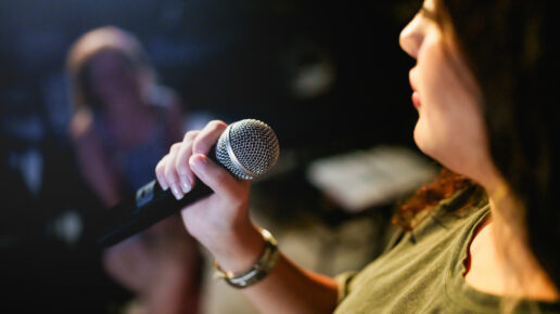 A woman performing arts on stage.