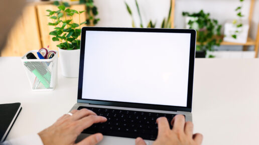 A person starting a blank laptop when trying to figure out which presentation topics they should use.