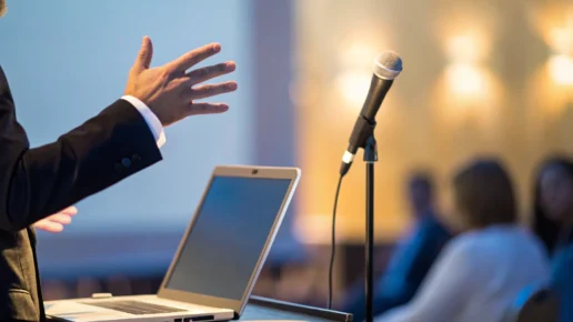 A person on stage giving a presentation and avoiding common mistakes.